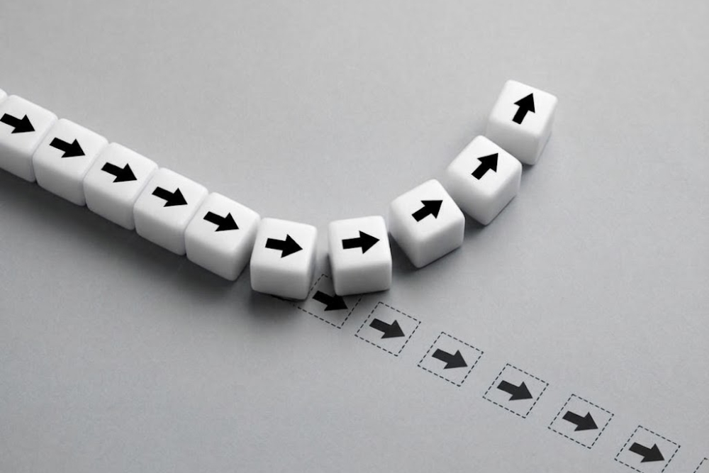 Career Reinvention - The Transformation Circle Row of white cubes with black arrows forming a curved path indicating a sequence or workflow.